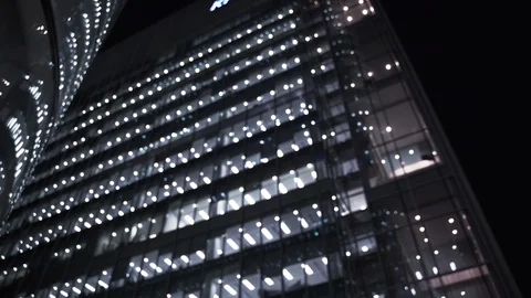 Blurred exterior of generic modern nyc atlanta chicago office building at night Stock Footage