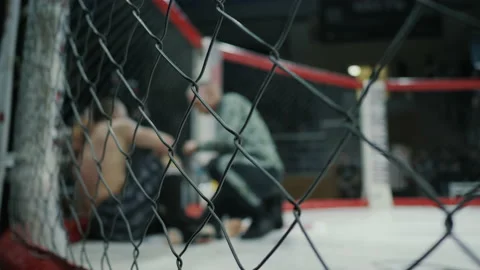 Blurred fighter in the interval between rounds in an octagon, drinks water Stock Footage 152593256