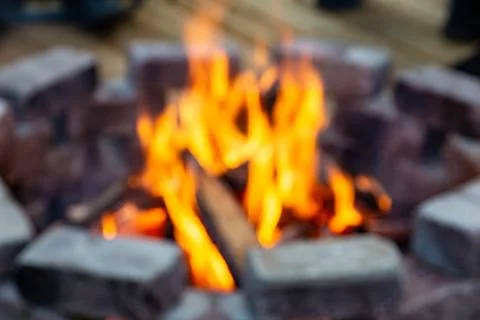 Blurred Fire burning in a stone brick fire pit made of blocks Stock Photos