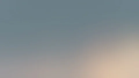 Blurred fluffy hazy clouds in the evening sky - seamless looping (4K) Video stock 127362391