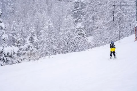 Blurred focus background. A boy lifting on the ski drag lift rope in blue sport Stock Photos
