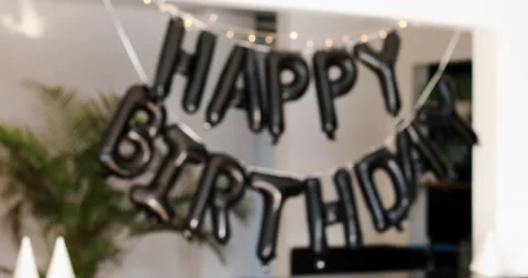 Blurred focus of black inflatable Happy Birthday words that flutter in the wind Stock Footage 151810730