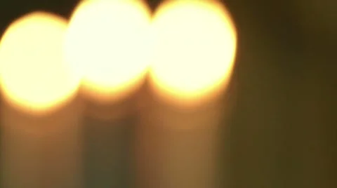 Blurred to focus three lit candles Stock Footage 20999652