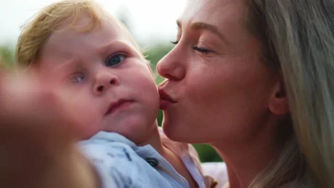 Blurred foreground hand frames mother and child Stock Footage 340886005