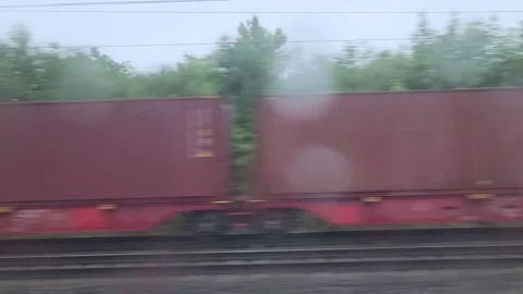 Blurred freight train in rain by forest 스톡 동영상 336741804