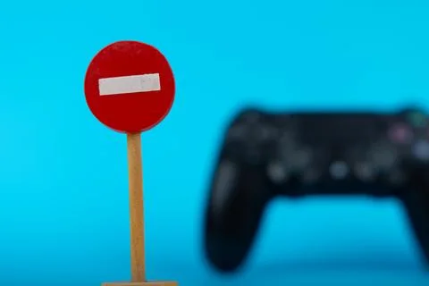 Blurred Game Controller with Wooden No Entry Sign Stock Photos