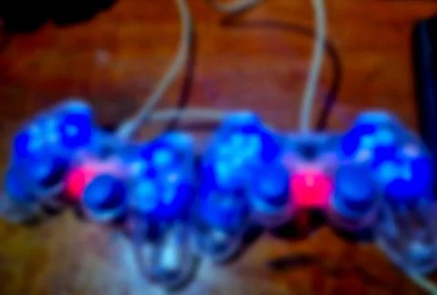 Blurred game controllers glowing Foto stock