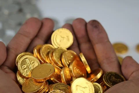 Blurred of gold coins stack in hands. Stock Photos