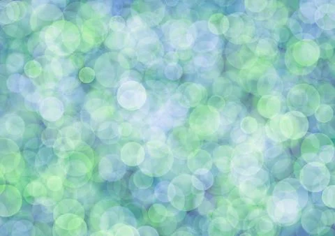 Blurred green background with light olive and blue circle sparkling lights. Stock Photos