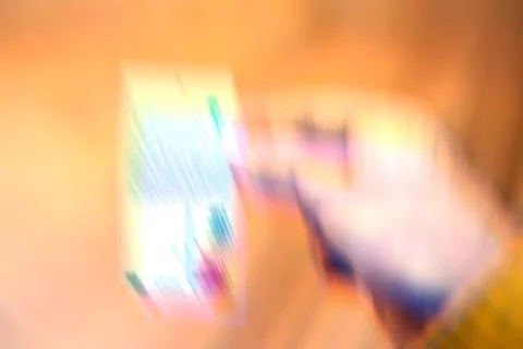 Blurred Hand Holding a Vibrant Object Stock-Illustration