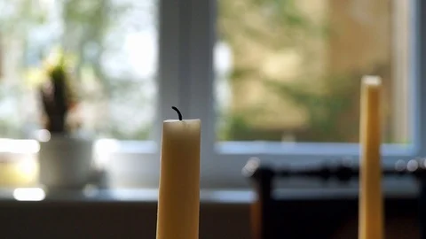 Blurred hand lighting candle in background Stock Footage 128305120