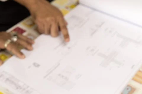 Blurred hand pointing structure blueprint. Stock Photos