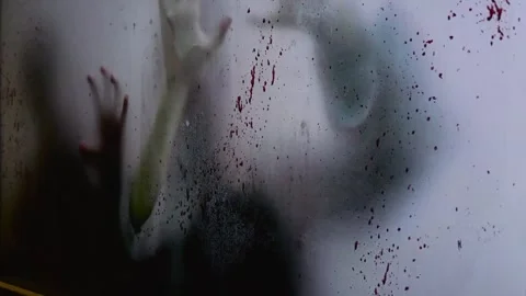 Blurred hands claw at blooded window, sign of deadly pandemic. Close-up of Stock Footage 255497059