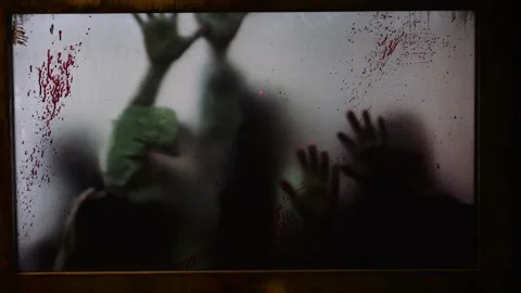 Blurred hands of maniac victims scratch at bloody window, scene of horrors Video stock 255579407