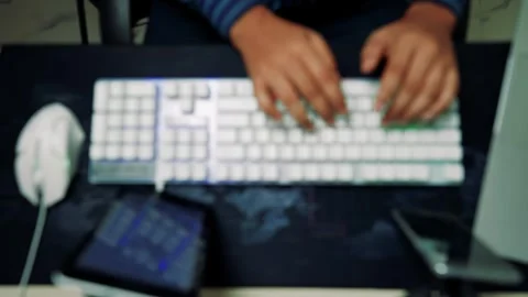 Blurred Hands Typing on Keyboard, Blurred image of hands typing on a keyboa.. Stock Footage 317737328
