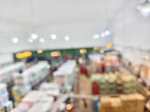 Blurred high-angle shot of a busy store interior with bright lights Stock Photos