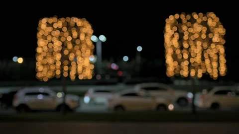 Blurred holiday background. Trees are decorated with golden lights on the Stockbeeldmateriaal 204778210