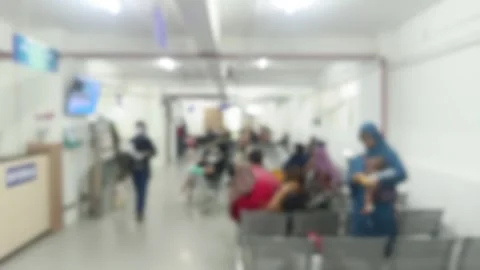Blurred hospital waiting area teeming with masked patients anticipating med.. Stock Footage 303831535
