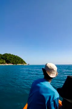 Blurred image and selective focus, un identified man in the boat over island  Fotos Stock