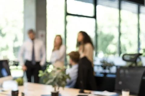 Blurred image of business people standing in the office. Stock Photos