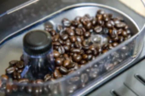 Blurred image of Coffee beans in a grinder. Stock Photos