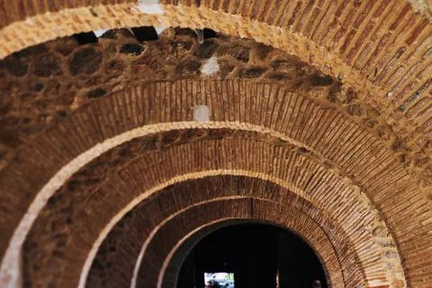 Blurred image. Corridor inside the building under construction. Brick wall, c Stock Photos
