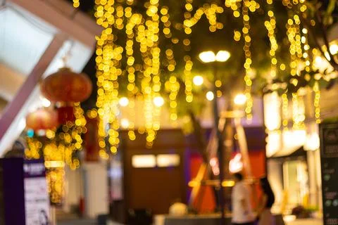 Blurred image Decorative outdoor string lights hanging on tree Stock Photos