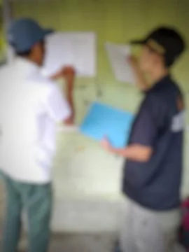 Blurred image depicting collaborative analysis and planning on a board Stock Photos
