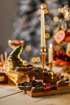 Blurred image of different types of bruschetta with cheese and fruits in a ca Stock Photos