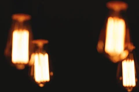 Blurred image of glowing retro light bulbs at night. Fotos Stock