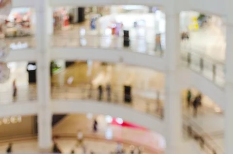 Blurred image - interior of large multistory shopping center. Stock Photos