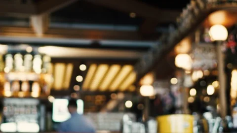 Blurred image of the interior of a large restaurant with bright lighting Stock Footage 100611853