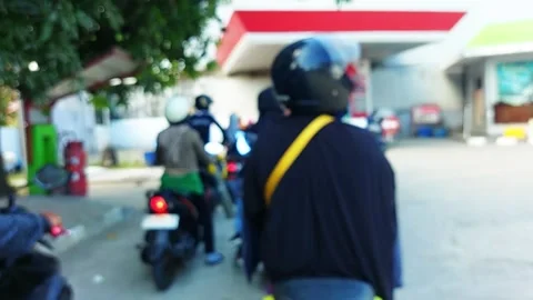 Blurred image of motorcyclists queuing at a gas station in Indonesia  Stock Footage 325180957