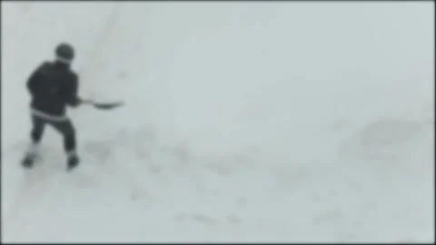 Blurred image of one person clearing snow with shovel during winter season. Cold Stock Footage 329214256