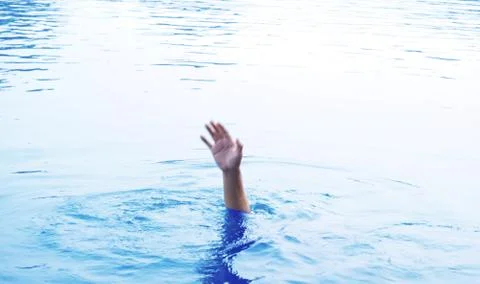 Blurred image, out of focus, people raising hands for help are drowning Stock Photos