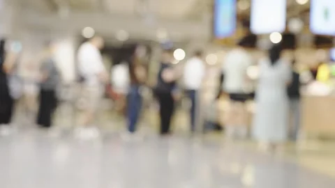 Blurred image of people standing in a queue at a modern food court or comme.. Video stock 331452917
