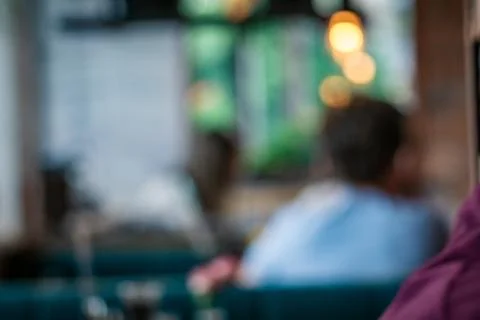 Blurred Image of a Person Sitting at a Table in a Restaurant Stock Photos