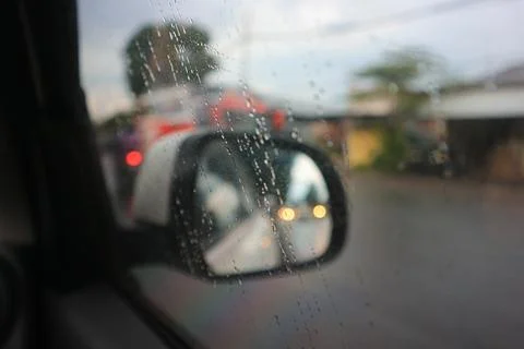 Blurred image of a raindrops on the windshield. Stock Photos