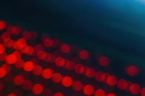 Blurred image of red LED lights in rows, creating a bokeh effect. Perfect f.. Stock Photos