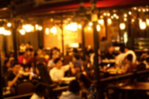 Blurred image at the restaurant night time, many people in the restaurant 스톡 사진