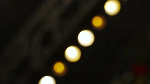 Blurred image of row of warm colored halogen lamps flickering and fading. Vídeo Stock 238740533