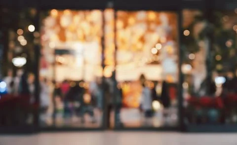 Blurred image of storefront with people inside abstract background Stock Photos