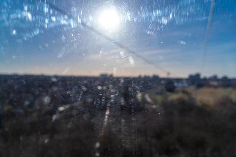 Blurred image of the sun through a scratched window pane for backgrounds Stock Photos
