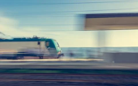 Blurred image of train passing through station. Stock Photos