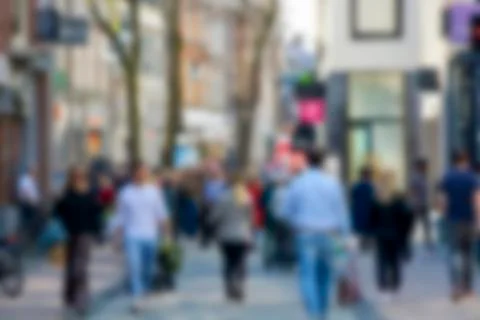 Blurred image of unrecognizable crowd of people shopping in the city street Stock Photos