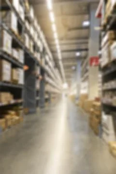 A blurred image of a warehouse full of empty cardboard boxes stacked on the.. Stock Illustration