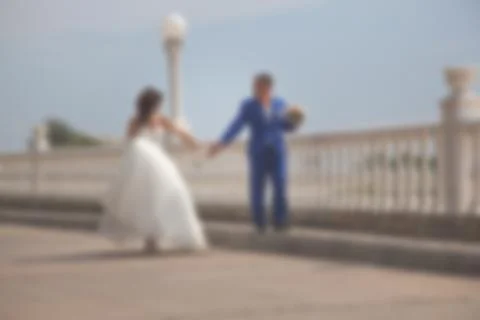Blurred image of a wedding theme on the beach of the embankment of a young co Stock Photos