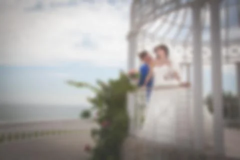 Blurred image of a wedding theme on the beach of the embankment of a young co Stock Photos