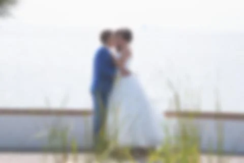 Blurred image of a wedding theme on the beach of the embankment of a young co Stock Photos