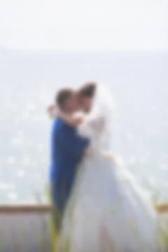Blurred image of a wedding theme on the beach of the embankment of a young co Stock Photos
